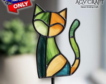 May include: A stained glass cat figurine with a black outline. The cat is composed of green, orange, and yellow glass pieces. The words "PATTERN ONLY" are in a red banner in the upper left corner. The AGV Craft logo is in the upper right corner.