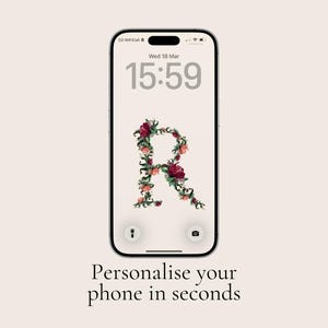 May include: A smartphone displays a floral letter "R" wallpaper. The screen shows the time as 15:59 on Wednesday, March 18. The phone's screen is surrounded by a cream-colored background. The text "Personalise your phone in seconds" is below the phone.