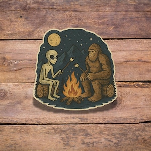 Alien and Bigfoot Campfire Sticker | Die Cut Grunge UFO Cryptid Vinyl Decal | Funny Night Camping Mountain Forest Outdoors Sticker