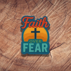 May include: A blue, green, orange, and yellow embroidered patch with the words "Faith over Fear" and a cross in the center.