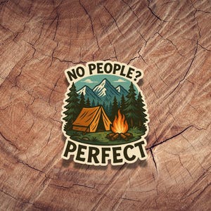 May include: A sticker with a camping scene featuring a tent, a campfire, and mountains. The text reads "No people? Perfect."