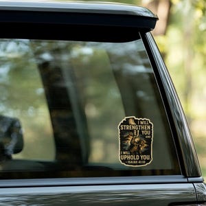Distressed-style sticker featuring a man in work gear being lifted by a divine hand with the text “I will strengthen you and I will uphold you – Isaiah 41:10” set against a stormy background with rays of light