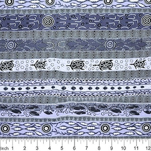 May include: A purple and grey fabric with a repeating pattern of Aboriginal art. The pattern includes turtles, fish, and other symbols. The fabric is 12 inches wide.