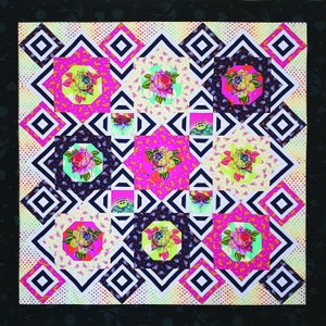 May include: A colorful quilt with a geometric pattern of black and white squares and diamonds. The squares and diamonds are filled with floral fabric in shades of pink, yellow, and green.