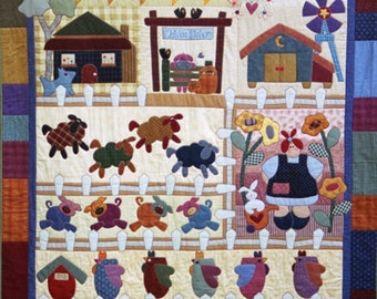 May include: A colorful quilted wall hanging depicting a farm scene with a white picket fence, a red barn, a house, a windmill, a sign that says "Coffee Saloon", a flying angel, and various farm animals including sheep, pigs, and chickens.