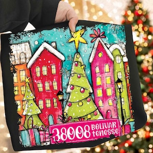 May include: Black tote bag with a festive Christmas design. The image shows colorful houses, Christmas trees, and presents. The text "38008 Bolivar, Tenesse" is displayed on a pink banner. The style is reminiscent of a hand-painted illustration.