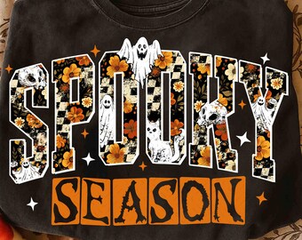 May include: Black sweatshirt with the words "SPOOKY SEASON" in orange and white. The word "SPOOKY" is filled with orange flowers, skulls, and ghosts. The word "SEASON" is in orange boxes.