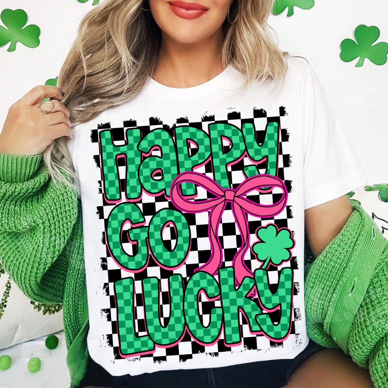 May include: White t-shirt with a green and black checkered design. The text "Happy Go Lucky" is written in green letters with a pink bow.