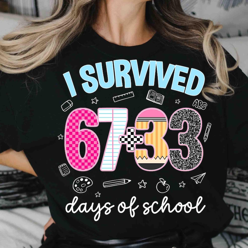 May include: Black t-shirt with the text "I Survived 67+33 days of school." The design includes a pink number 6, a white number 7, a pencil, and a glittery number 3. School-themed graphics surround the text.