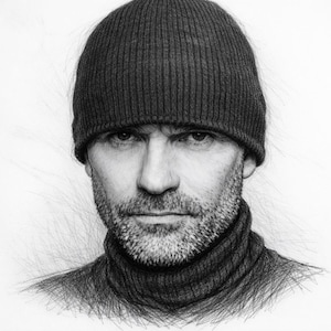 May include: A black and white graphite pencil drawing of a person wearing a ribbed knit beanie and a high-neck jumper. The subject has a short beard and a focused expression, with detailed shading capturing the texture of the fabric and facial hair.