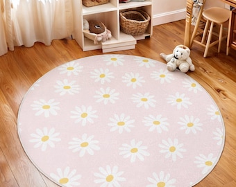 May include: A pink round rug with a white daisy pattern. The daisies have yellow centers.