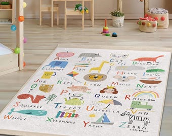 May include: A colorful alphabet rug with illustrations of animals, objects, and letters. The rug features a white background with a beige border. The letters are in a playful font and the illustrations are bright and cheerful.