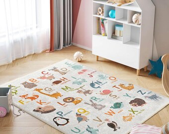 May include: A colorful alphabet playmat with animal illustrations and letters. The mat features a variety of animals, including a fox, giraffe, lion, penguin, unicorn, and vulture. The letters are printed in a bold, easy-to-read font.