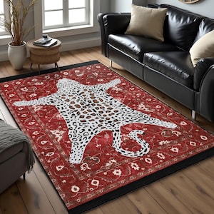May include: Red and black area rug with a white and brown leopard print design. The rug has a traditional Persian style pattern.