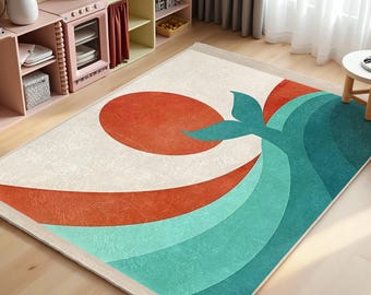 May include: A white, cream, orange, and teal area rug with a stylized whale tail design. The rug has a fringe border.