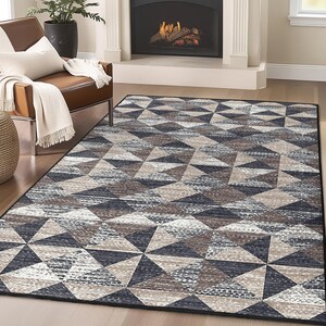May include: A geometric patterned rug with a black, gray, and brown color scheme. The rug has a modern design with a repeating pattern of triangles.
