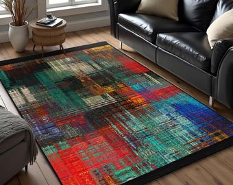 May include: Abstract area rug with a black border. The rug features a colorful geometric pattern with shades of red, orange, yellow, green, blue, and black.