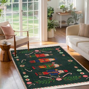 May include: A rectangular area rug with a dark green background features colorful nutcracker figures. The rug is bordered with a red and white striped pattern and candy cane and peppermint accents. The rug is placed on a hardwood floor.