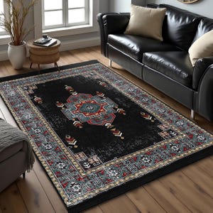 May include: Black and red area rug with a geometric pattern. The rug has a distressed look and a border with a floral design.
