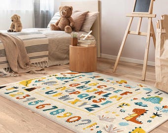 May include: A white and cream alphabet rug with colorful letters, numbers, and dinosaur illustrations. The rug features a light blue, yellow, and orange color scheme.