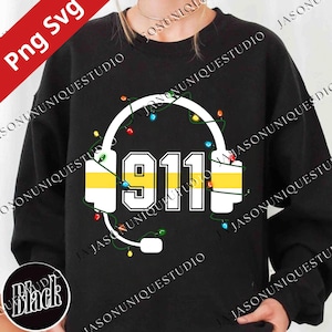 May include: Black sweatshirt featuring a white headset design with the number "911" in the center. The headset has yellow stripes and is decorated with colorful string lights. The text "Png Svg" is in the upper left corner.