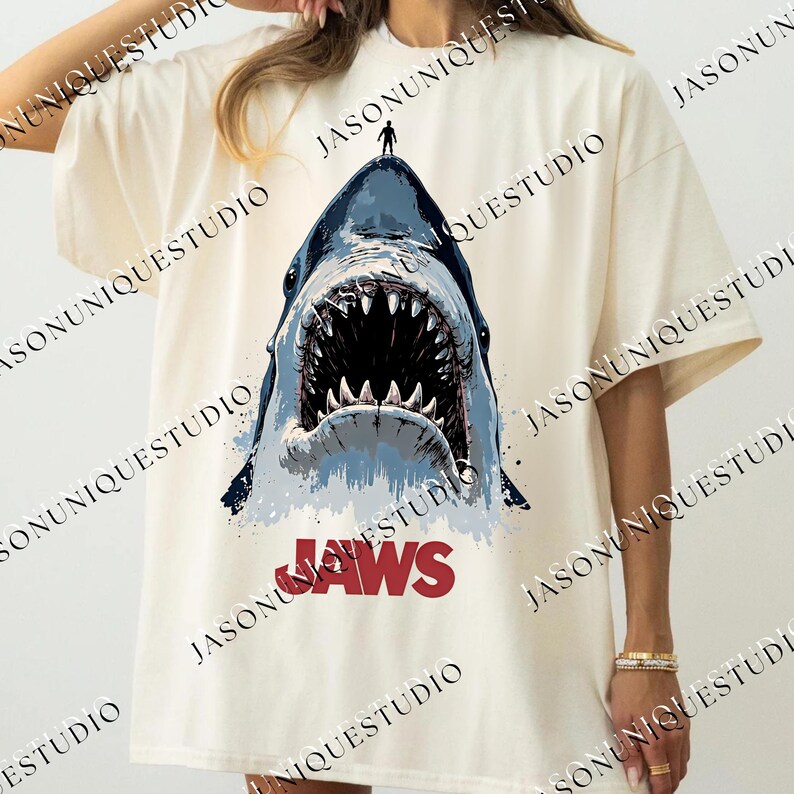 a woman wearing a t - shirt with a shark on it