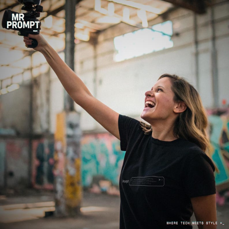 May include: A woman holding a video camera, with the text "MR PROMPT" in the upper left corner. She is wearing a black t-shirt with the word "prompt" and a text box graphic. The background features graffiti art and an industrial setting.