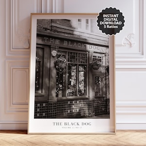 May include: Black and white framed print of a pub facade, "The Black Dog," with hanging flower baskets and detailed windows. The print includes the text "Instant Digital Download 5 Ratios" and "Volume 11 No 17."