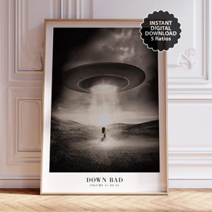 May include: Sepia-toned art print featuring a UFO hovering over a figure in a field. The print includes the text "DOWN BAD" and "VOLUME 11 NO 04". A sticker indicates an instant digital download with 5 ratios.