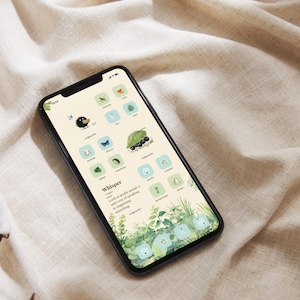 May include: A smartphone displays a custom home screen with nature-themed app icons. The icons feature illustrations of birds, leaves, and insects. The background is a soft beige with a green and blue color scheme. The word "Whisper" is displayed on the screen.