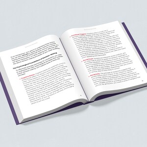 May include: An open book displays text about the psychological foundations of decision-making. The pages are white with black text, and the book has a purple cover. The text includes concepts like cognitive biases and emotional triggers, relevant to marketing and sales.