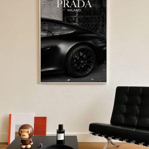 Old money fashion style black-and-white Porsche artwork with Prada-inspired text, creating a moody luxury aesthetic. This elegant print is ideal for old money prints, old money aesthetic décor, and upscale fashion poster displays. Perfect for lovers of luxury prints, luxury car poster décor, and designer interiors seeking prada fashion inspired poster styling and dark elegance minimalist fashion home decor accents.