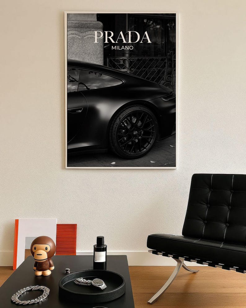 Old money fashion style black-and-white Porsche artwork with Prada-inspired text, creating a moody luxury aesthetic. This elegant print is ideal for old money prints, old money aesthetic décor, and upscale fashion poster displays. Perfect for lovers of luxury prints, luxury car poster décor, and designer interiors seeking prada fashion inspired poster styling and dark elegance minimalist fashion home decor accents.