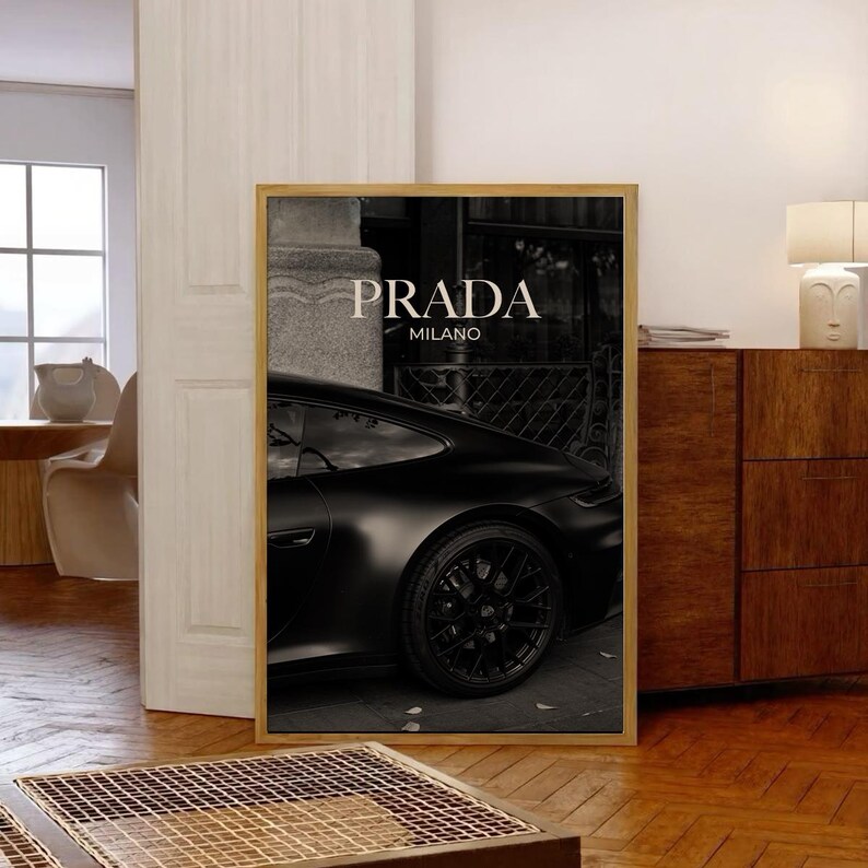 Old money fashion style black-and-white Porsche artwork with Prada-inspired text, creating a moody luxury aesthetic. This elegant print is ideal for old money prints, old money aesthetic décor, and upscale fashion poster displays. Perfect for lovers of luxury prints, luxury car poster décor, and designer interiors seeking prada fashion inspired poster styling and dark elegance minimalist fashion home decor accents.