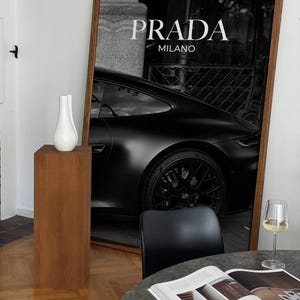 Old money fashion style black-and-white Porsche artwork with Prada-inspired text, creating a moody luxury aesthetic. This elegant print is ideal for old money prints, old money aesthetic décor, and upscale fashion poster displays. Perfect for lovers of luxury prints, luxury car poster décor, and designer interiors seeking prada fashion inspired poster styling and dark elegance minimalist fashion home decor accents.