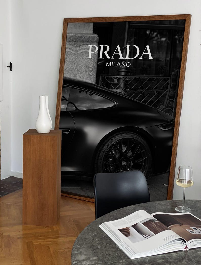 Old money fashion style black-and-white Porsche artwork with Prada-inspired text, creating a moody luxury aesthetic. This elegant print is ideal for old money prints, old money aesthetic décor, and upscale fashion poster displays. Perfect for lovers of luxury prints, luxury car poster décor, and designer interiors seeking prada fashion inspired poster styling and dark elegance minimalist fashion home decor accents.