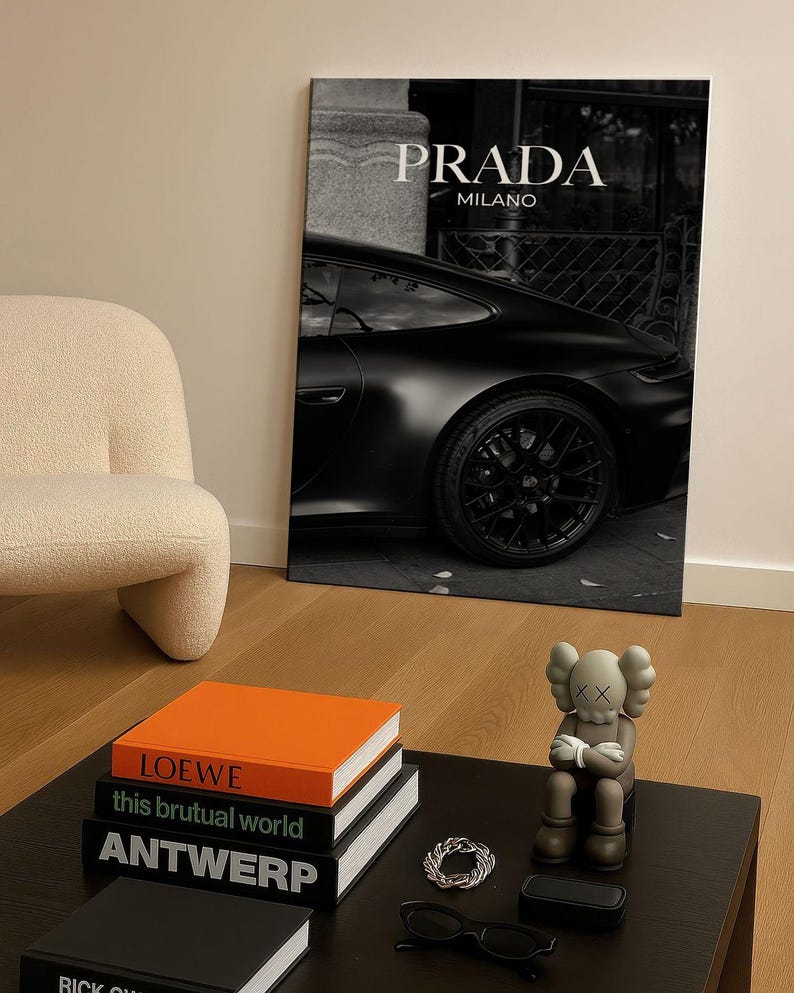 Old money fashion style black-and-white Porsche artwork with Prada-inspired text, creating a moody luxury aesthetic. This elegant print is ideal for old money prints, old money aesthetic décor, and upscale fashion poster displays. Perfect for lovers of luxury prints, luxury car poster décor, and designer interiors seeking prada fashion inspired poster styling and dark elegance minimalist fashion home decor accents.