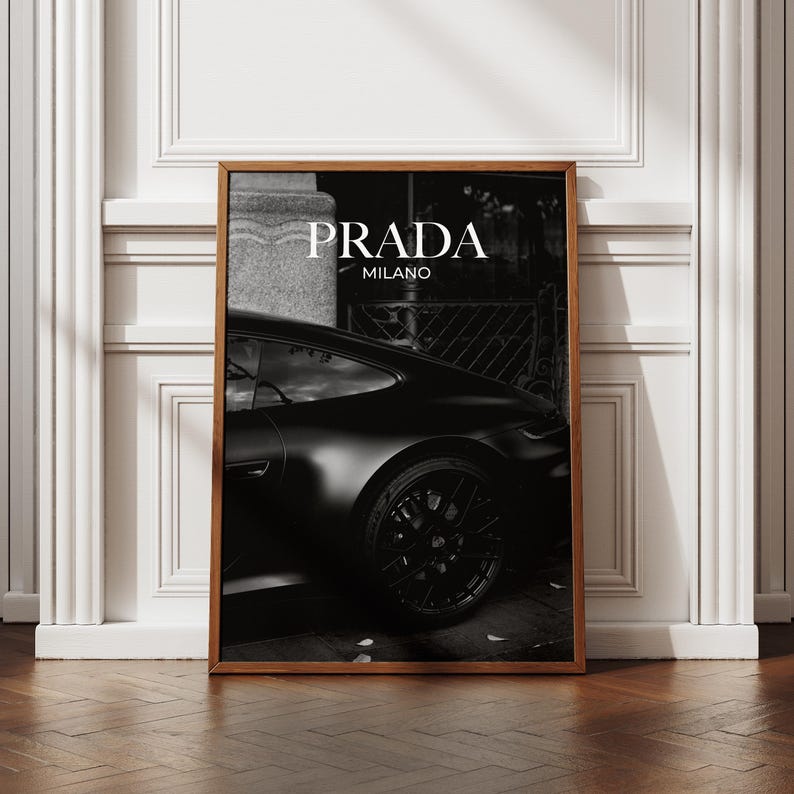 Old money fashion style black-and-white Porsche artwork with Prada-inspired text, creating a moody luxury aesthetic. This elegant print is ideal for old money prints, old money aesthetic décor, and upscale fashion poster displays. Perfect for lovers of luxury prints, luxury car poster décor, and designer interiors seeking prada fashion inspired poster styling and dark elegance minimalist fashion home decor accents.