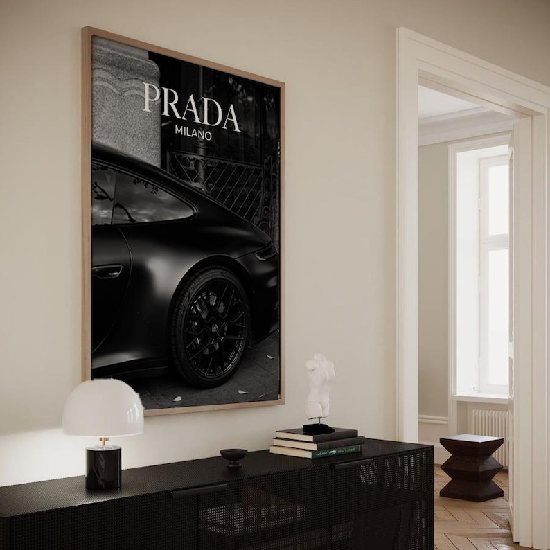 Old money fashion style black-and-white Porsche artwork with Prada-inspired text, creating a moody luxury aesthetic. This elegant print is ideal for old money prints, old money aesthetic décor, and upscale fashion poster displays. Perfect for lovers of luxury prints, luxury car poster décor, and designer interiors seeking prada fashion inspired poster styling and dark elegance minimalist fashion home decor accents.