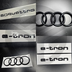 Puede incluir: Calcomanías en blanco y negro con el texto "e-tron" y "s quattro" para la personalización del automóvil. Las calcomanías se muestran sobre un fondo blanco.
