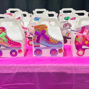 Puede incluir: Cajas de regalo blancas con diseños de patines de ruedas coloridos. Los patines están decorados con lazos, estrellas y alas. Las cajas están sobre una superficie rosa, perfectas para una fiesta.