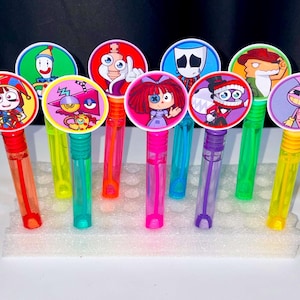 May include: A collection of nine colorful bubble wands, each topped with a circular character illustration. The translucent plastic tubes are filled with liquid and feature diverse cartoon designs, including clowns, animals, and figures in vibrant colors.