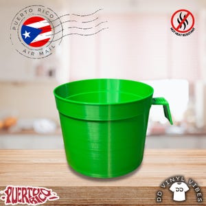 May include: A bright green plastic mug with a single handle. The image features a circular Puerto Rico Air Mail stamp, a red circle with a line through a flame icon labeled NOT HEAT RESISTANT, and a logo with the text DD VINYL VIBES.