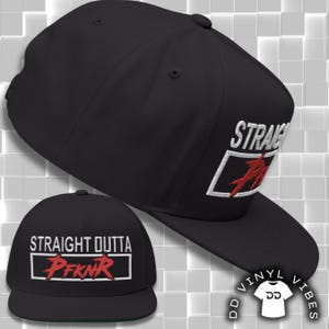 May include: Black baseball cap featuring the embroidered text "STRAIGHT OUTTA" and "PFKNR" in white and red. The cap has a flat peak and a structured design, ideal for everyday wear.
