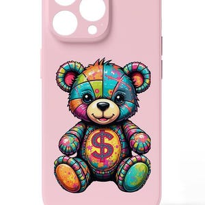 May include: A pink phone case with a colorful cartoon teddy bear holding a dollar sign. The bear is made up of different colored patches and has a happy expression.