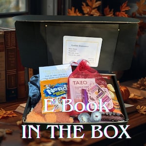 May include: An open black box filled with various items, including a book, snacks, tea, and stickers. The box has the text "E Book IN THE BOX" on the front. A label reads "Gothic Romance."