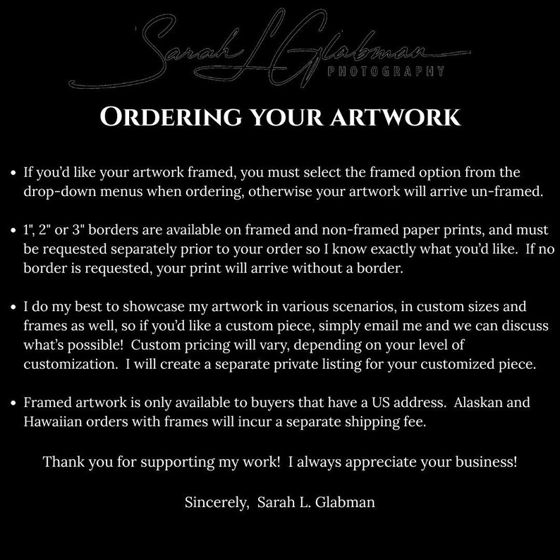 The image is a black and white photograph of a sign with text and a signature.