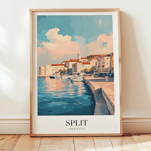 May include: A framed art print of Split, Croatia, featuring a coastal scene with buildings, boats, and a serene body of water. The artwork has a watercolor style with a light wooden frame. The text "SPLIT CROATIA" is at the bottom.