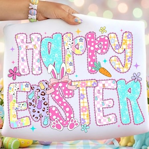 May include: White rectangular pillow with the words "HAPPY EASTER" in colorful, patterned letters. The design includes bunny ears, a carrot, flowers, and Easter eggs, perfect for spring decor.