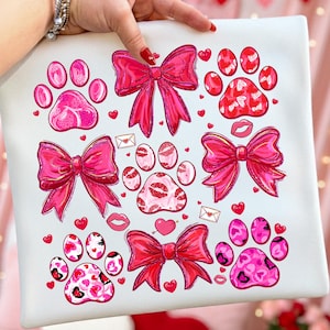 May include: A white ceramic mug with a black handle and the text "But First, Coffee" in a bold, black font. The mug is set against a blurred background, suggesting a cozy setting.